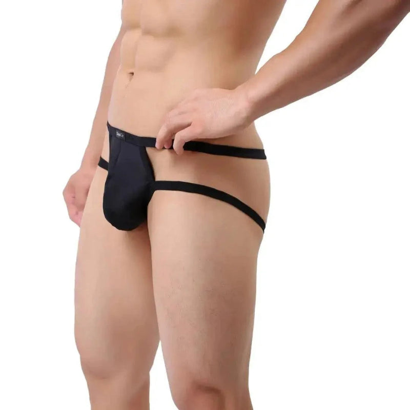 DomiGe X-Design jockstrap in black — model side view showing low-rise fit and waistband straps	