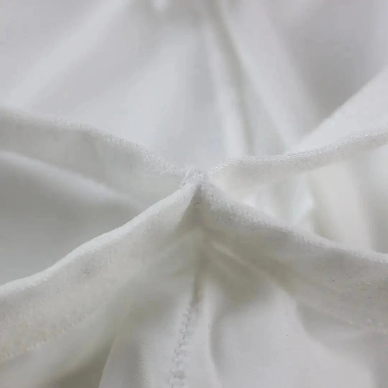 DomiGe X-Design jockstrap in white — flat lay side view showing waistband and strap construction	