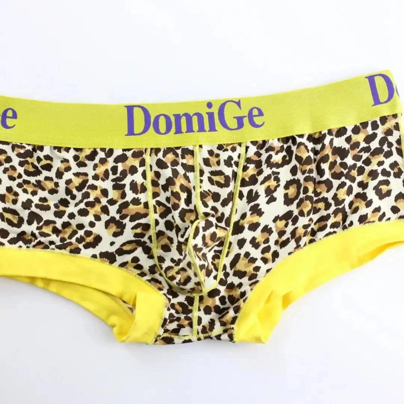 DomiGe low-rise trunks yellow product flat lay — gold logo waistband ribbed leg openings full design	